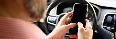 A man inside a car calling for vehicle support.