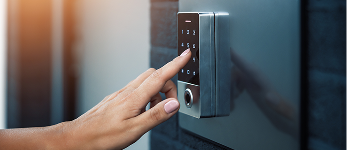 Hand entering code on smart keypad lock