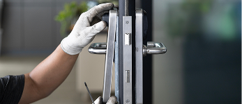 An installation of a door handle with locks at a new residence.